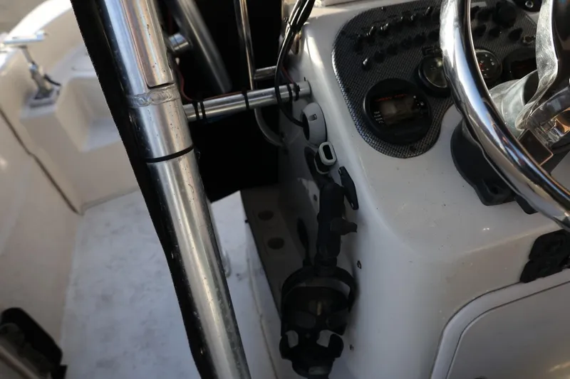 Slide: The Image of 2013 Carolina Skiff 178 DLV boat dashboard with steering wheel and controls. - 25
