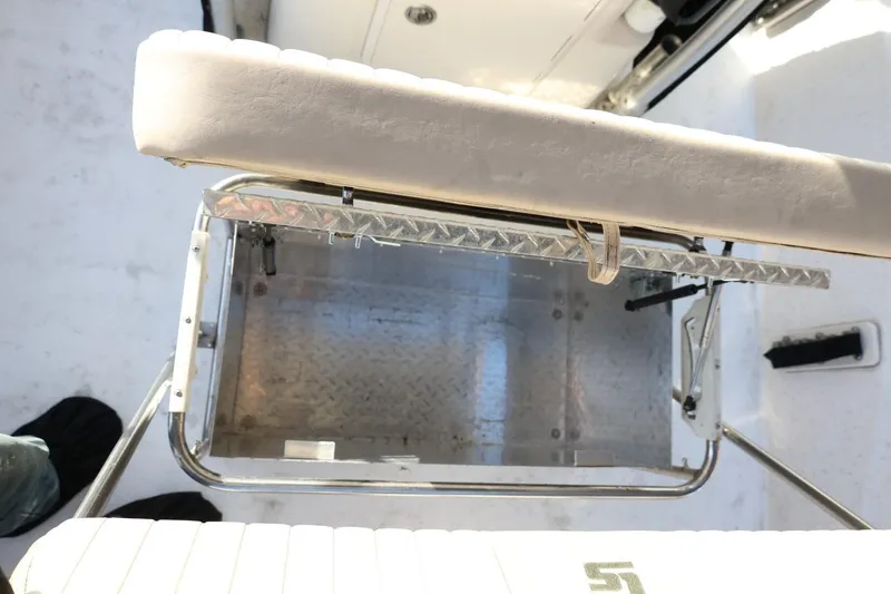 Slide: The Image of 2013 Carolina Skiff 178 DLV boat interior with cushioned seating and metal framework. - 27