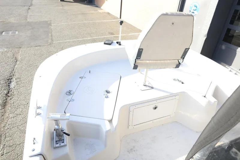 Slide: The Image of 2013 Carolina Skiff 178 DLV boat interior with seating and storage compartments. - 29