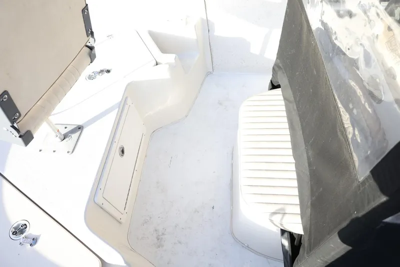 Slide: The Image of 2013 Carolina Skiff 178 DLV boat interior with seating and storage compartments. - 30