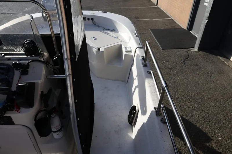 Slide: The Image of 2013 Carolina Skiff 178 DLV boat interior with steering console and railings. - 36