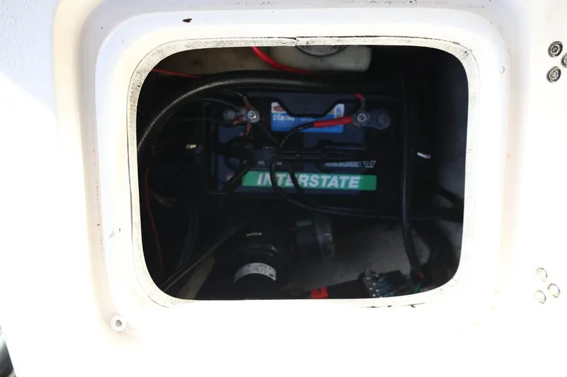 Slide: The Image of Battery compartment of a 2013 Carolina Skiff 178 DLV boat, featuring an Interstate battery. - 40