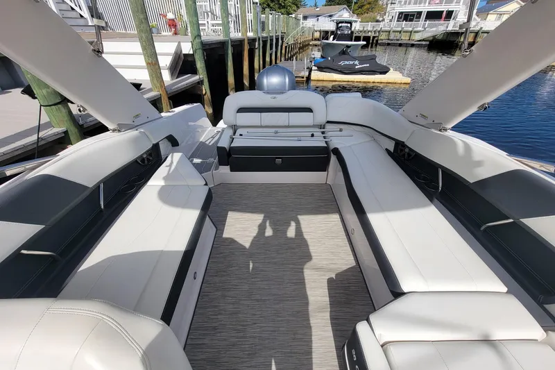 Slide: The Image of 2018 Regal 26 OBX boat canopy with residential background and clear blue sky. - 10