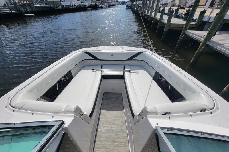 Slide: The Image of 2018 Regal 26 OBX boat interior with spacious seating and modern design at a dock. - 11