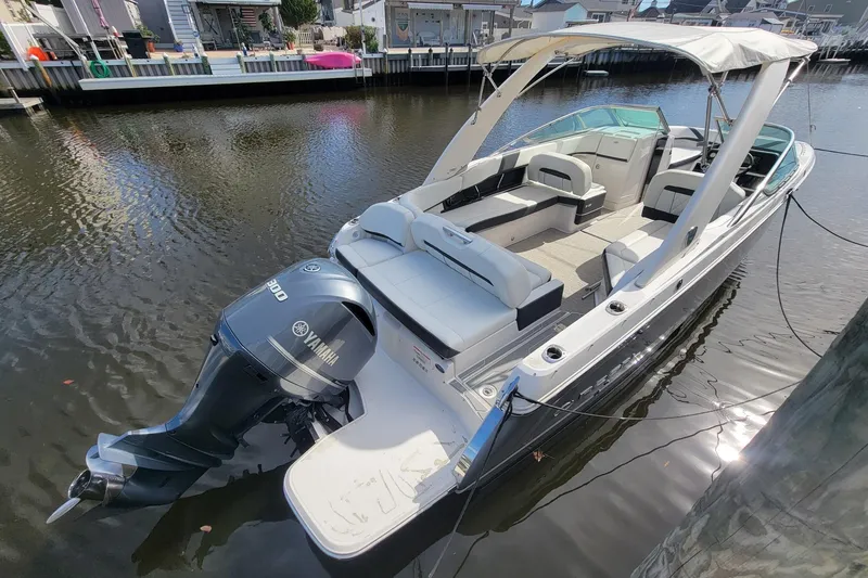 Slide: The Image of 2018 Regal 26 OBX boat docked in a residential canal setting. - 3