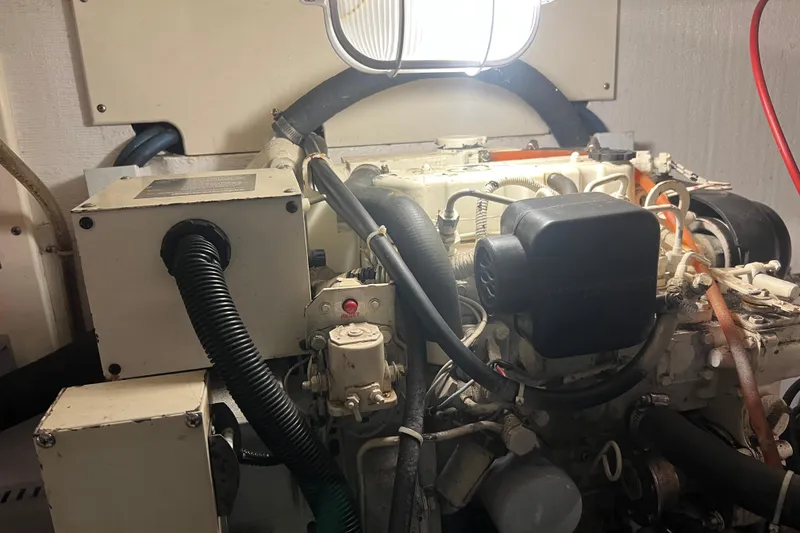 Slide: The Image of Engine room of a 2004 Henriques 35 Sportfisherman boat, featuring mechanical components. - 101