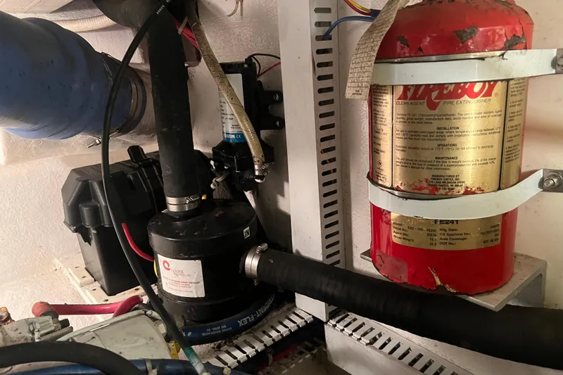 Slide: The Image of Engine room of 2004 Henriques 35 Sportfisherman with fire extinguisher and equipment. - 102