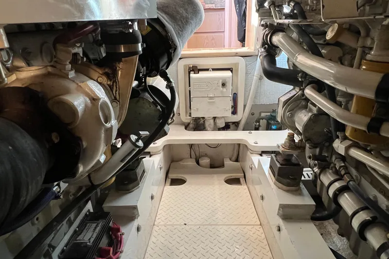 Slide: The Image of Engine room of a 2004 Henriques 35 Sportfisherman, showcasing mechanical components and layout. - 104