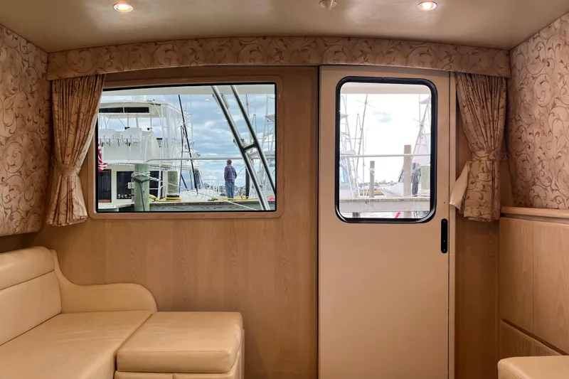 Slide: The Image of Interior of 2004 Henriques 35 Sportfisherman with window view of marina. - 106