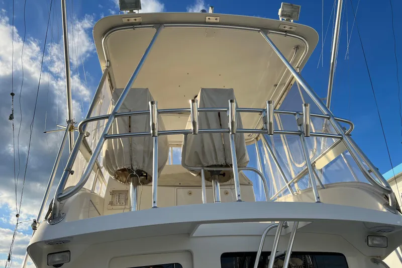 Slide: The Image of 2004 Henriques 35 Sportfisherman boat with covered seats and clear skies. - 108