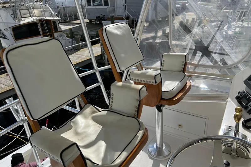 Slide: The Image of 2004 Henriques 35 Sportfisherman helm with cushioned seats and marina view. - 116