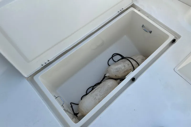 Slide: The Image of Open storage compartment on 2004 Henriques 35 Sportfisherman with boat fenders inside. - 12