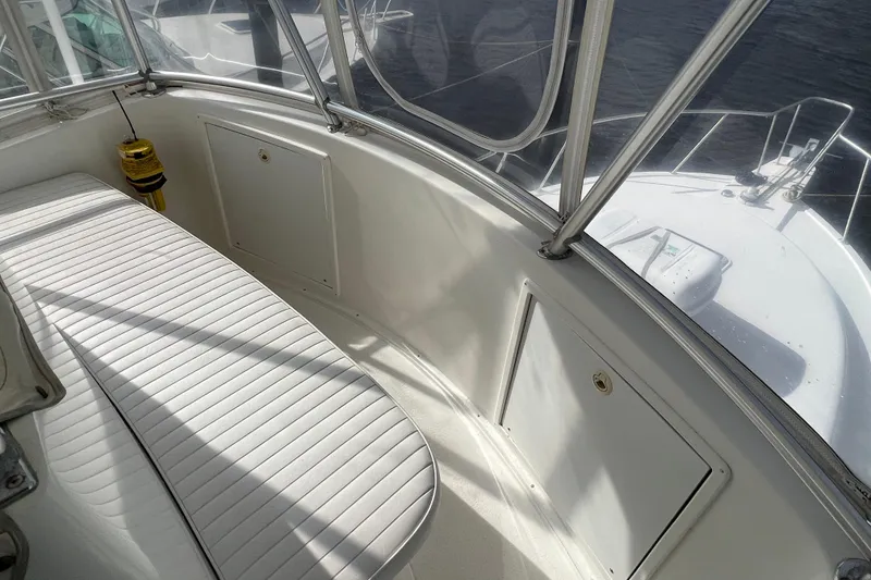 Slide: The Image of 2004 Henriques 35 Sportfisherman boat interior with white seating and storage compartments. - 120