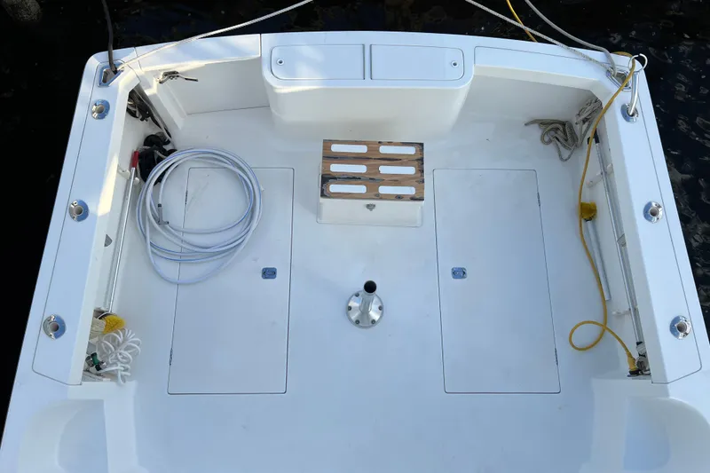 Slide: The Image of 2004 Henriques 35 Sportfisherman boat deck with fishing equipment and storage compartments. - 123