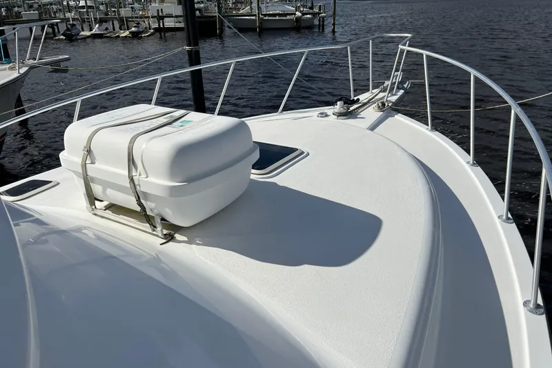 Slide: The Image of 2004 Henriques 35 Sportfisherman boat deck with life raft, docked at marina. - 125
