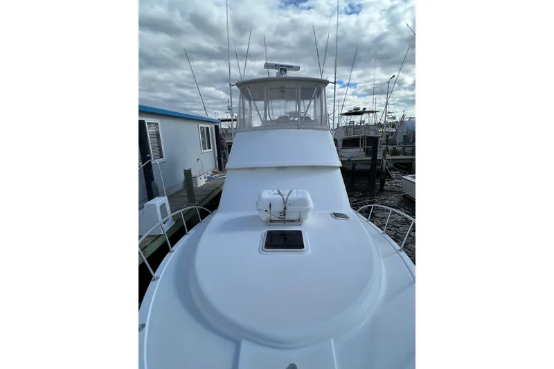 Slide: The Image of 2004 Henriques 35 Sportfisherman boat docked under cloudy skies. - 127