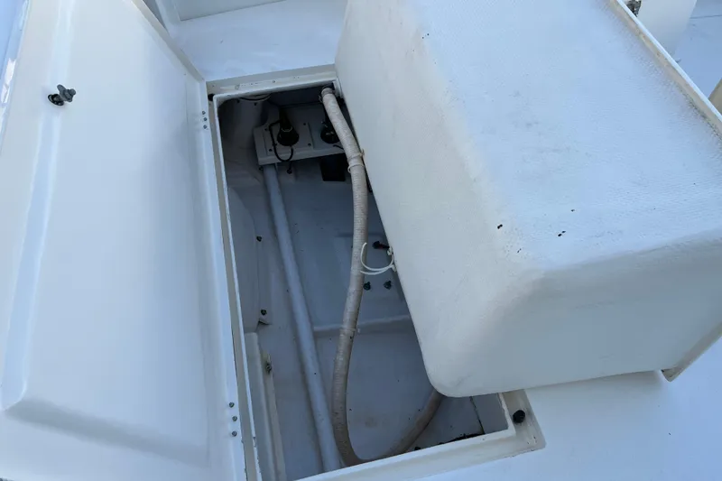 Slide: The Image of Open storage compartment on 2004 Henriques 35 Sportfisherman boat, showing interior details. - 13