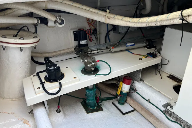 Slide: The Image of Engine compartment of a 2004 Henriques 35 Sportfisherman, showcasing mechanical components and wiring. - 14