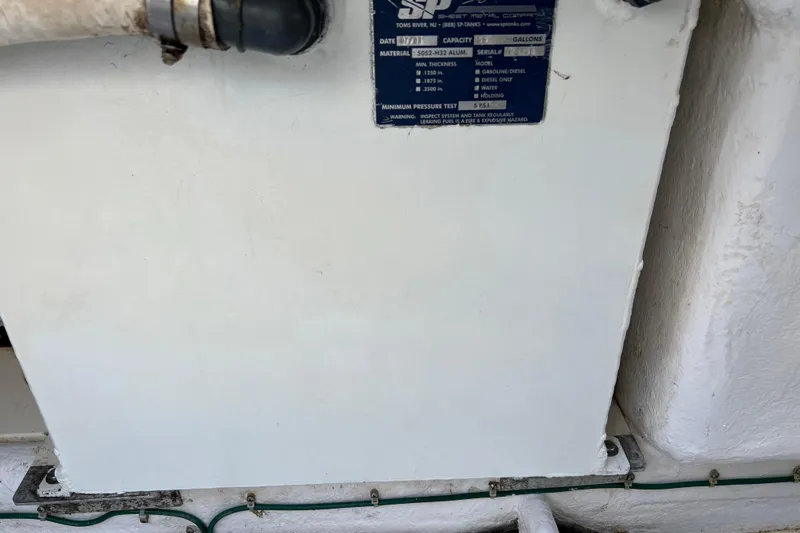 Slide: The Image of 2004 Henriques 35 Sportfisherman engine compartment with visible label and piping. - 15