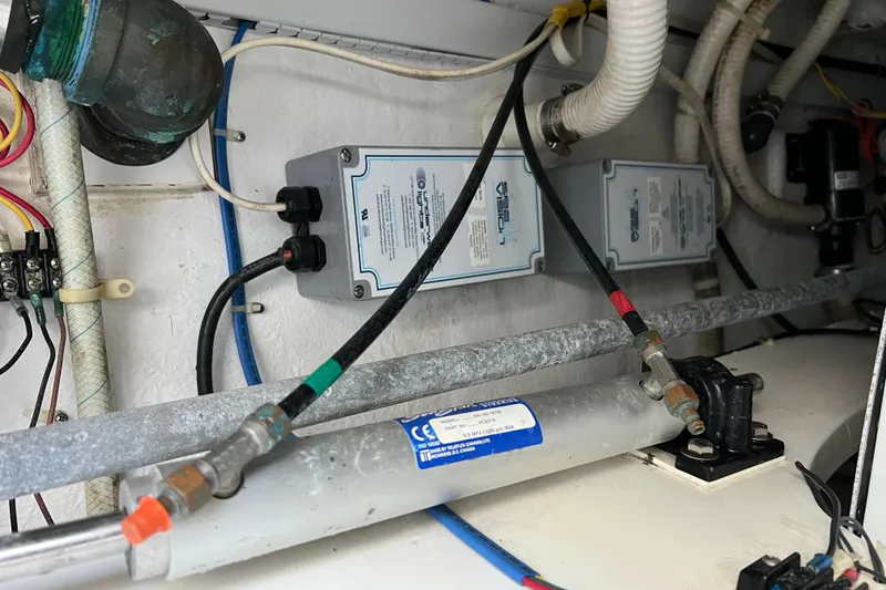 Slide: The Image of Engine room of 2004 Henriques 35 Sportfisherman, showcasing electrical and plumbing components. - 16