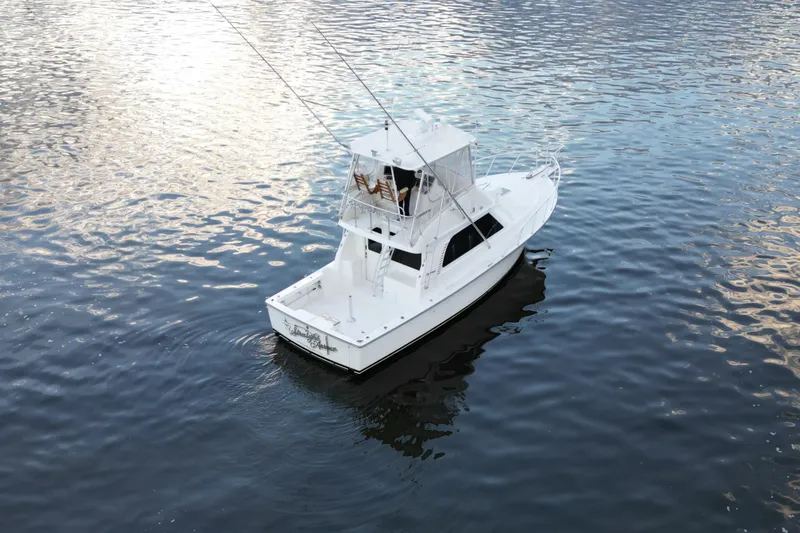 Slide: The Image of 2004 Henriques 35 Sportfisherman boat on calm water, aerial view. - 2