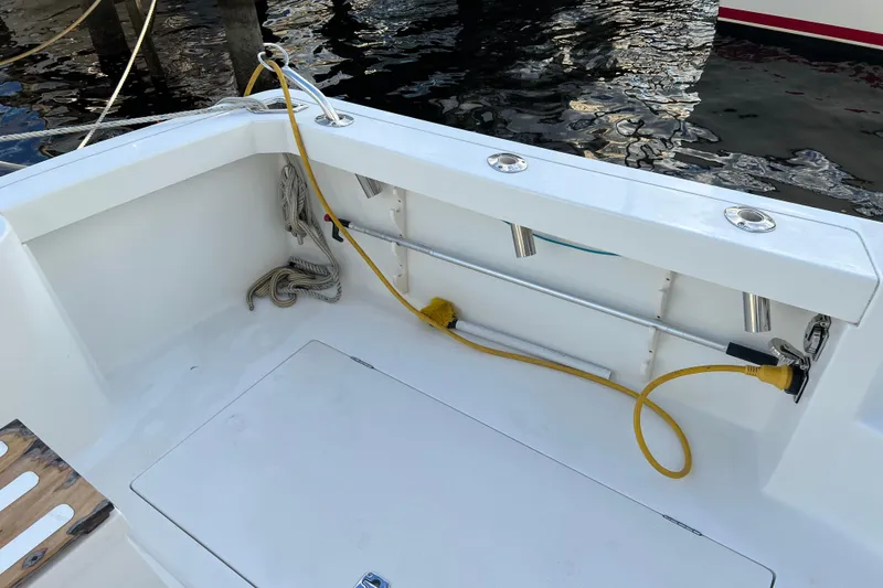 Slide: The Image of 2004 Henriques 35 Sportfisherman boat deck with fishing rod holders and coiled rope. - 20