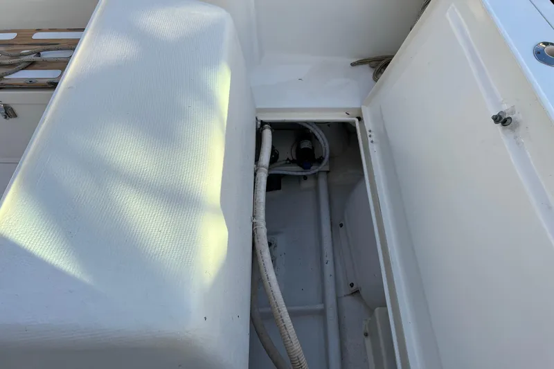 Slide: The Image of 2004 Henriques 35 Sportfisherman boat interior, showing storage compartment and seating area. - 25