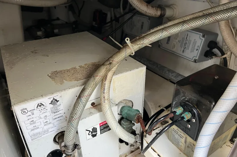 Slide: The Image of Engine compartment of a 2004 Henriques 35 Sportfisherman, showing mechanical components and wiring. - 27