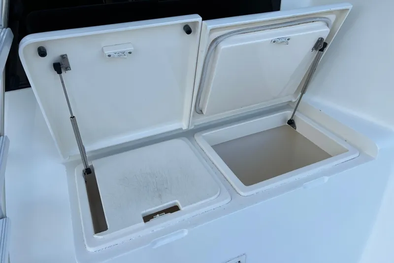 Slide: The Image of Open storage compartments on a 2004 Henriques 35 Sportfisherman boat. - 30