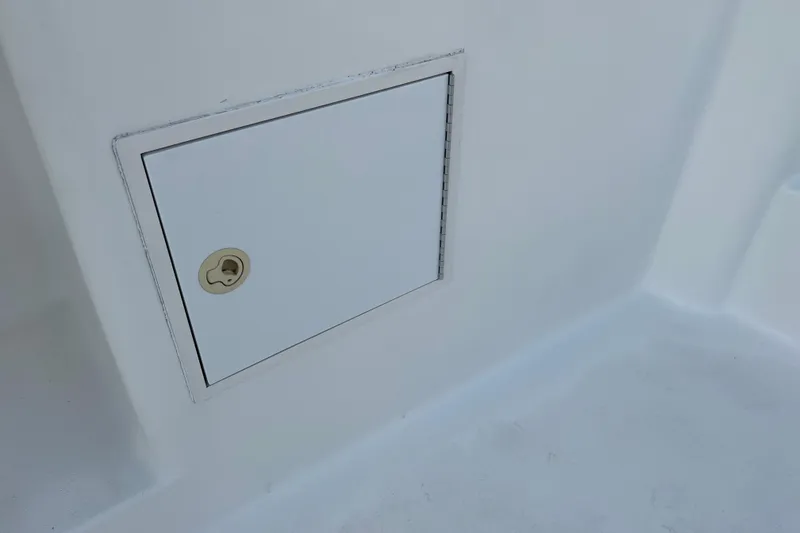Slide: The Image of Access hatch on 2004 Henriques 35 Sportfisherman boat, featuring a secure lock. - 33
