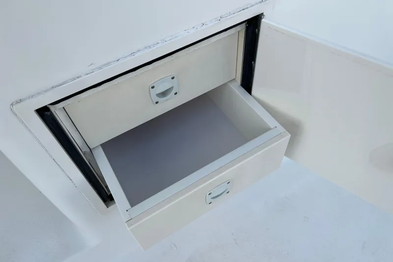 Slide: The Image of Open storage compartment on 2004 Henriques 35 Sportfisherman boat. - 34