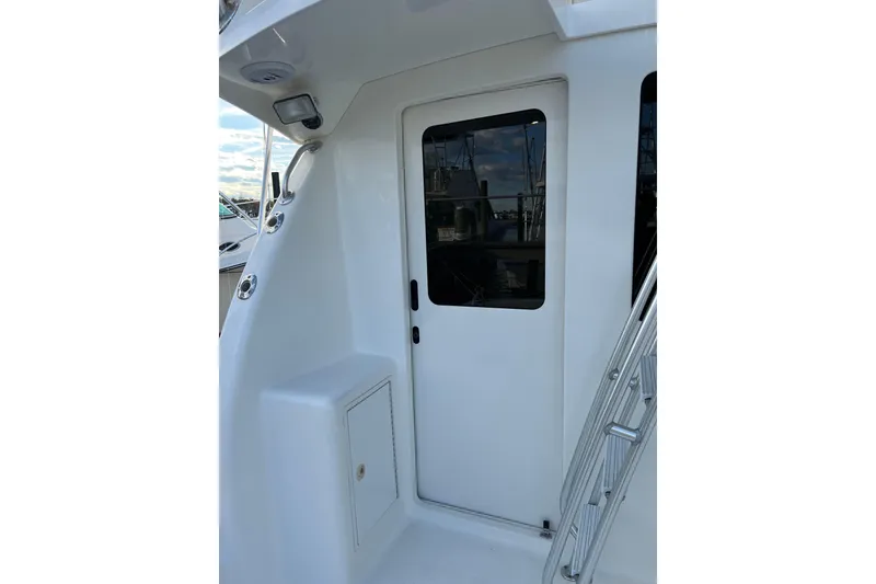 Slide: The Image of 2004 Henriques 35 Sportfisherman boat exterior with door and ladder detail. - 35