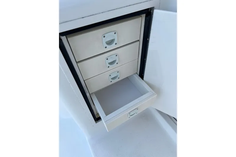 Slide: The Image of Storage drawers on a 2004 Henriques 35 Sportfisherman boat, open drawer visible. - 36