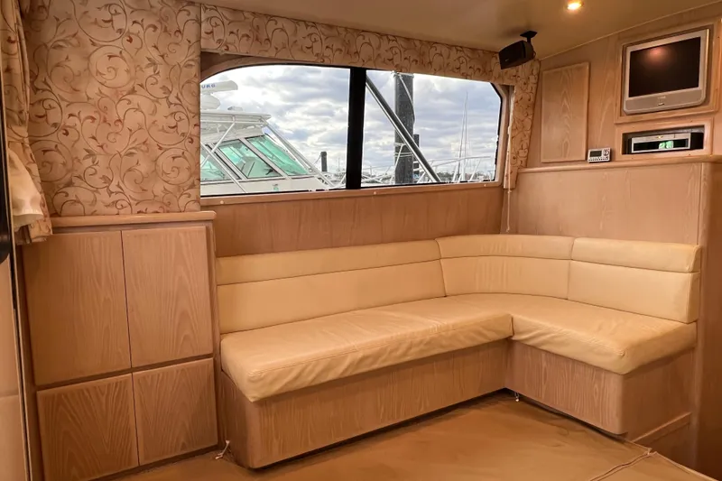 Slide: The Image of Interior of 2004 Henriques 35 Sportfisherman with beige seating and wood paneling. - 38