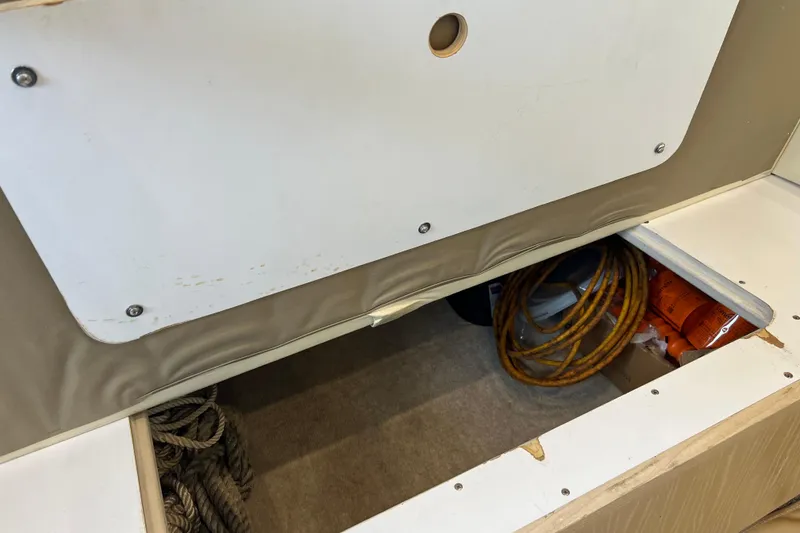 Slide: The Image of Storage compartment in a 2004 Henriques 35 Sportfisherman, containing ropes and equipment. - 44