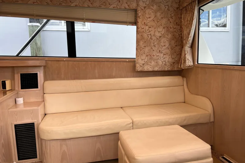 Slide: The Image of Interior of 2004 Henriques 35 Sportfisherman with beige seating and patterned curtains. - 47