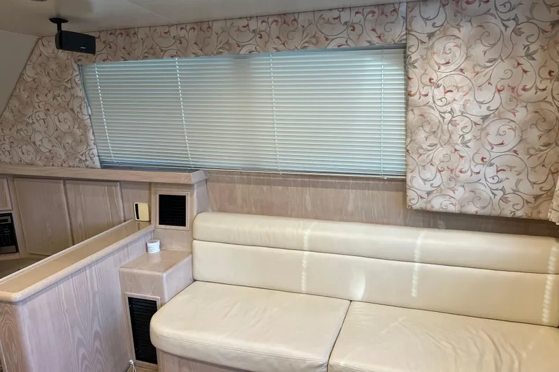 Slide: The Image of Interior of 2004 Henriques 35 Sportfisherman with beige seating and floral curtains. - 48