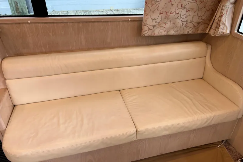 Slide: The Image of Cream leather sofa inside 2004 Henriques 35 Sportfisherman boat cabin. - 49