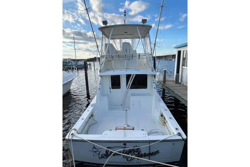 Slide: The Image of 2004 Henriques 35 Sportfisherman docked at marina under blue sky. - 5