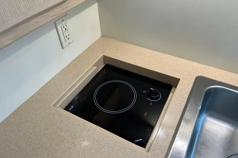 Slide: The Image of Built-in stovetop and sink in 2004 Henriques 35 Sportfisherman boat kitchen. - 54