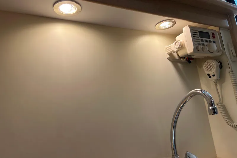 Slide: The Image of Interior of 2004 Henriques 35 Sportfisherman with radio, faucet, and overhead lighting. - 55