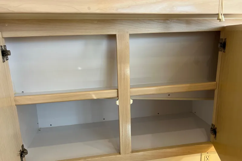 Slide: The Image of Empty wooden cabinet interior on a 2004 Henriques 35 Sportfisherman boat. - 56