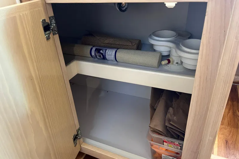 Slide: The Image of Open cabinet on Henriques 35 Sportfisherman 2004, storing rolls and containers. - 60