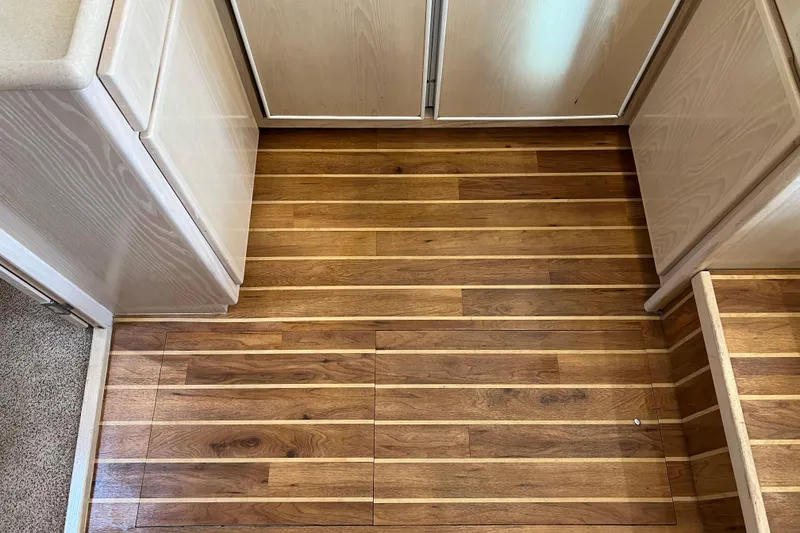 Slide: The Image of Wooden flooring in a 2004 Henriques 35 Sportfisherman boat interior. - 62