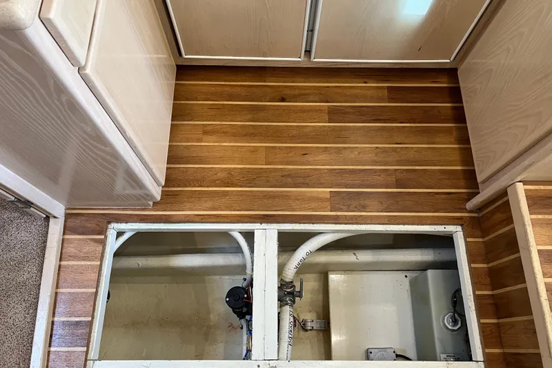 Slide: The Image of 2004 Henriques 35 Sportfisherman interior with open floor hatch revealing plumbing. - 63