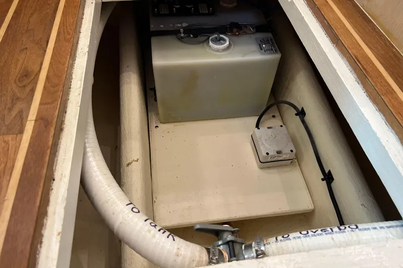 Slide: The Image of 2004 Henriques 35 Sportfisherman interior showing storage compartment with tank and piping. - 64