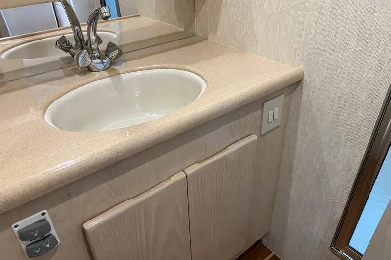 Slide: The Image of 2004 Henriques 35 Sportfisherman bathroom sink with beige countertop and modern faucet. - 67