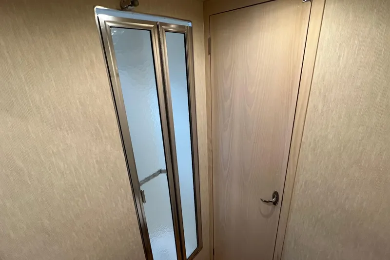 Slide: The Image of Interior of 2004 Henriques 35 Sportfisherman, featuring a wooden door and mirrored panel. - 70