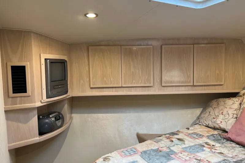 Slide: The Image of Cozy cabin interior of 2004 Henriques 35 Sportfisherman with TV and storage cabinets. - 79