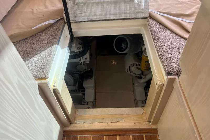 Slide: The Image of Engine compartment of 2004 Henriques 35 Sportfisherman boat, showing mechanical components. - 82